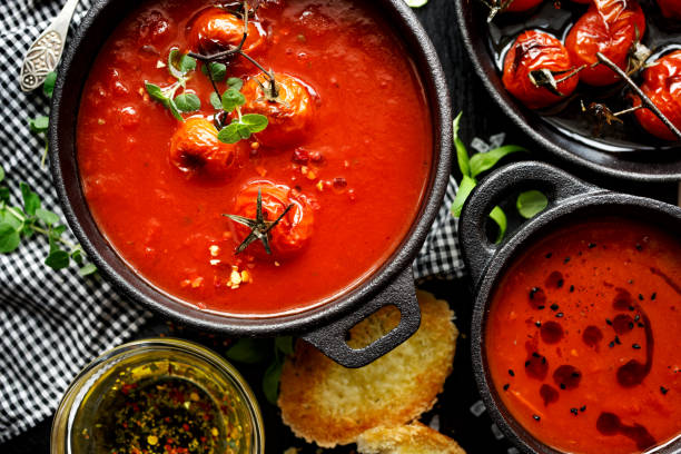 istock Tomato soup with roasted tomatoes, top view 909909544