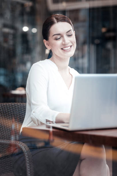 istock Cheerful lady looking at screen of her computer 909914022