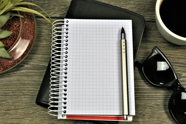 istock An concept Image of a Notebook with glasses, coffee and a flower 909914460