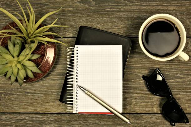 istock An concept Image of a Notebook with glasses, coffee and a flower 909914506