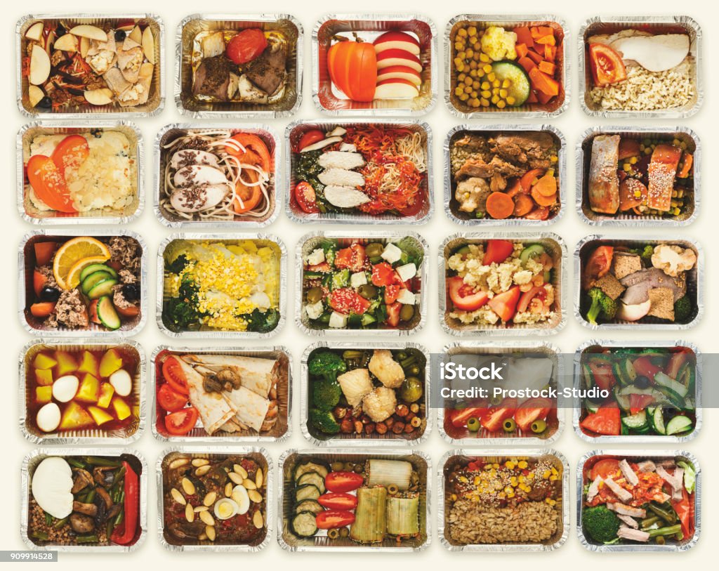 Set of take away food boxes at white background Collection of take away foil boxes with healthy food. Set of containers with everyday meals - meat, vegetables and law fat snacks on white background, top view Meal Stock Photo