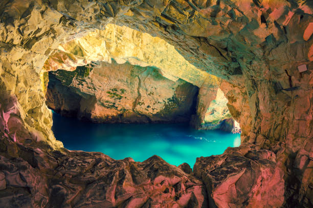 istock Natural grottoes in cave with calm sea 909918532