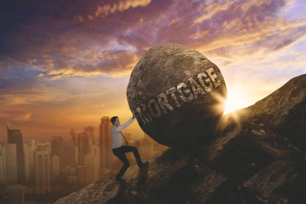 istock Caucasian businessman pushing mortgage word 909919184