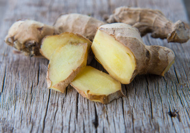 istock Close up Fresh ginger on wood texture. 909919284