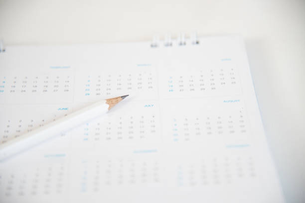 istock White calendar with pencil in planning concept. 909919356