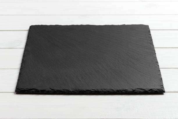 Slate blackboard on wooden table on wooden background