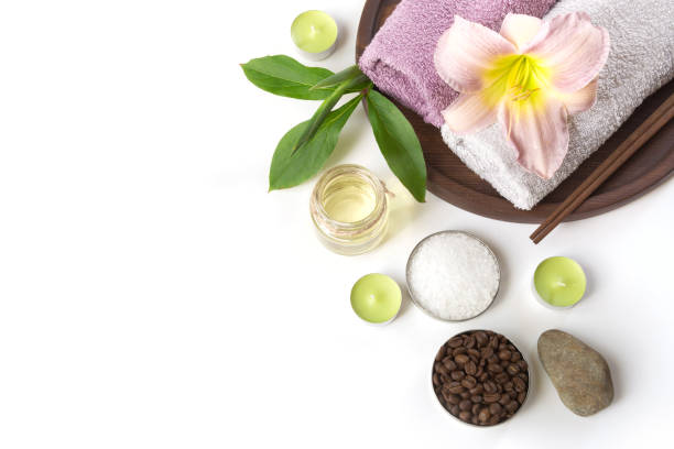 istock Spa setting of towel, flower on white background with copy space. Close up. Top view. 909927922