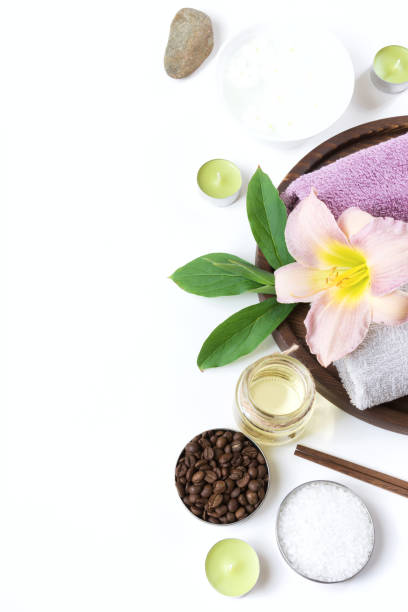 istock Spa setting of towel, flower, coffee beans on white background with copy space. Relax. 909927924