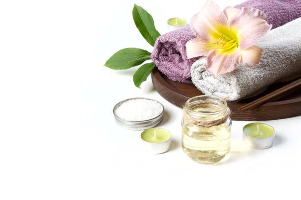 istock Spa setting of towel, flower on white background with copy space. Close up. Top view. 909927928