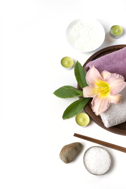 istock Spa setting of towel, flower on white background with copy space. Close up. Top view. 909927938