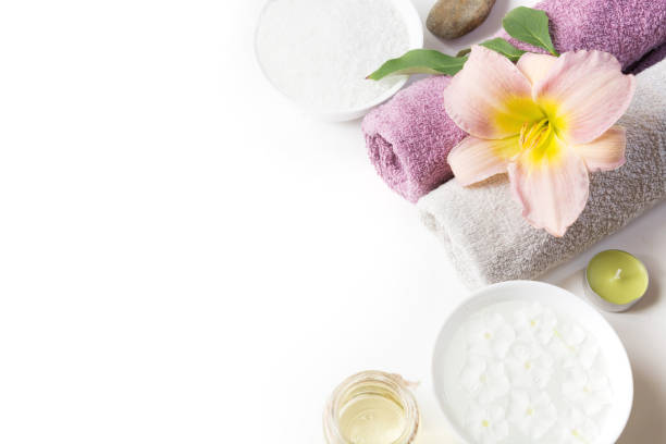 istock Spa setting of towel, flower, coffee beans on white background with copy space. Relax. 909927940