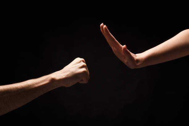 istock Stop violence against women background, isolated on black 909927962