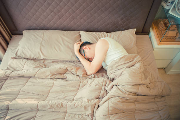 istock Depressed Asian man blaming on the phone on bed 909930718