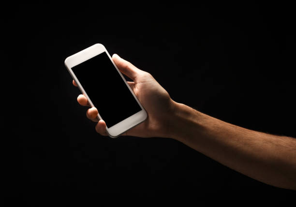 istock Male hand holding mobile smartphone with blank screen 909931136
