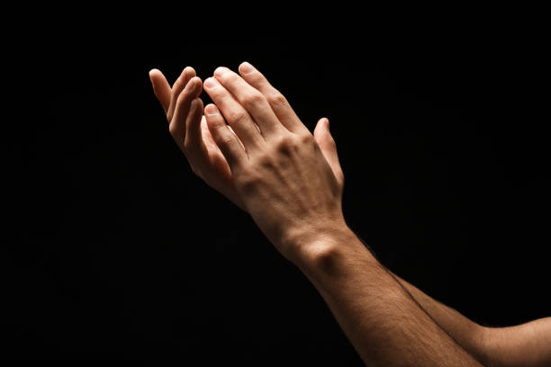 istock Man keeping hands in cupped shape, cutout on black 909931392