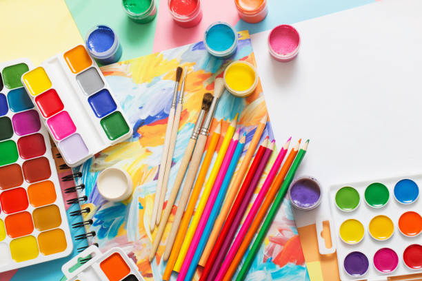 istock paints, pencils and brushes on paper 909931496