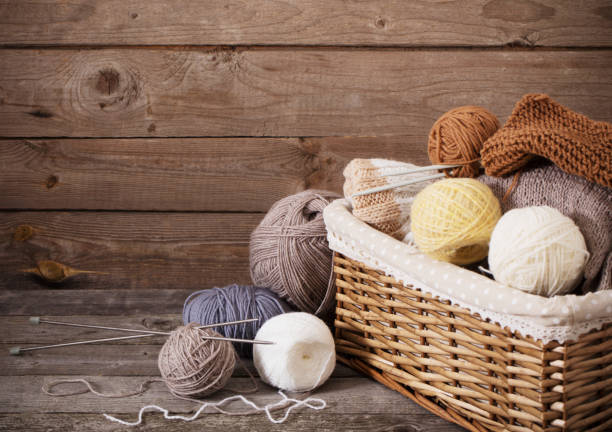 istock Knitting and knitting needles on a wooden surface 909931618