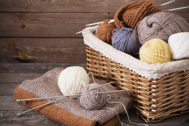 istock Knitting and knitting needles on a wooden surface 909931626