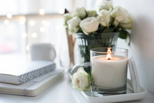istock White room interior decor with burning hand-made candle and bouq 909932008