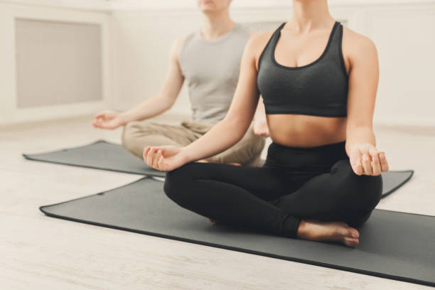 istock Young couple meditating together in studio 909932028