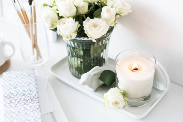 istock White room interior decor with burning hand-made candle and bouq 909932084