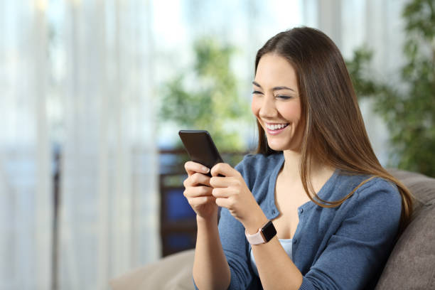 istock Woman wearing a smartwatch using a mobile phone 909932416