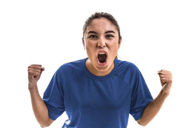 istock Female athlete / fan on blue uniform celebrating on white background 909932542
