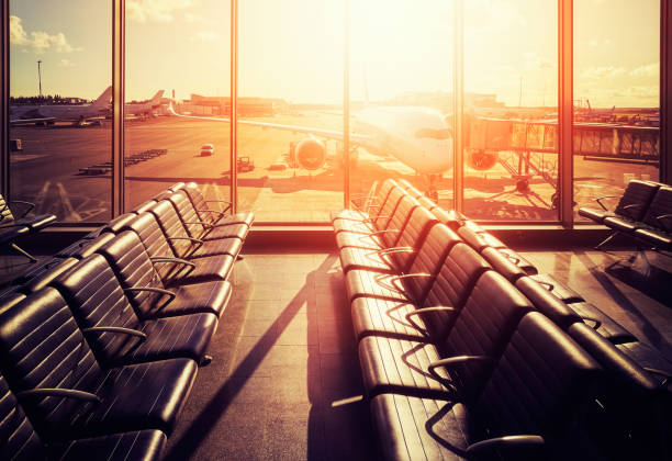 istock Empty seats in an airport departure hall at sunset. 909935102