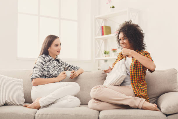 istock Two young female friends with coffee conversing 909935444