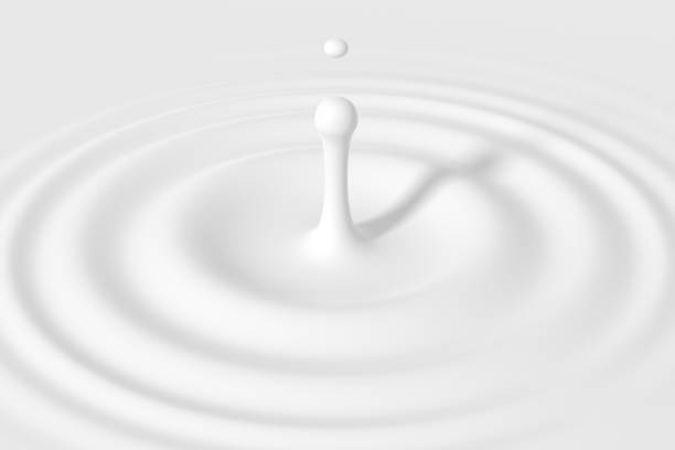 Drop falling into cream or milk stock photo