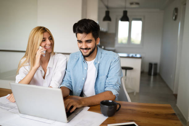 istock Handsome young man and attractive woman working on laptop 909938736