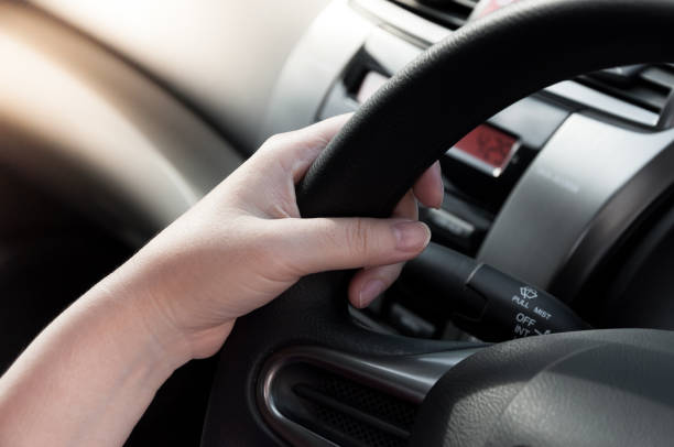 istock woman hand holding on black steering wheel 909939506