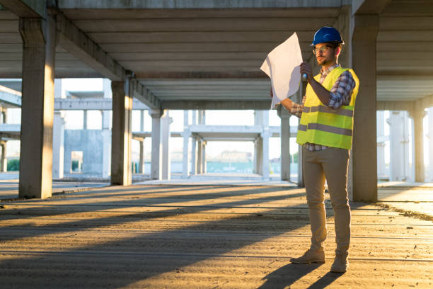 istock Picture of construction site engineer looking at plan 909942070