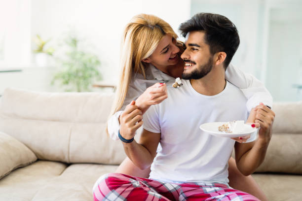 istock Cute young cheerful couple spending time at home 909942624