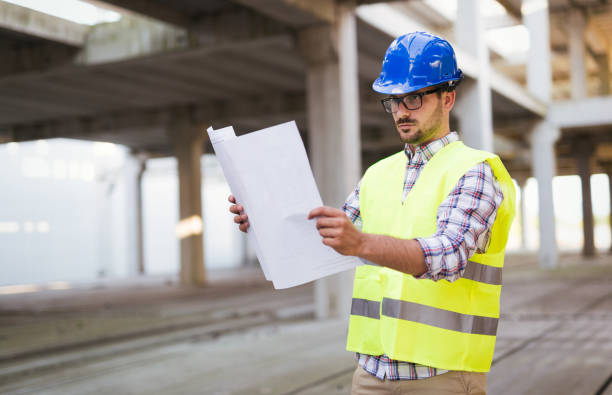 istock Picture of construction site engineer looking at plan 909942698