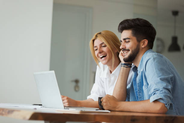 istock Handsome young man and attractive woman working on laptop 909942928
