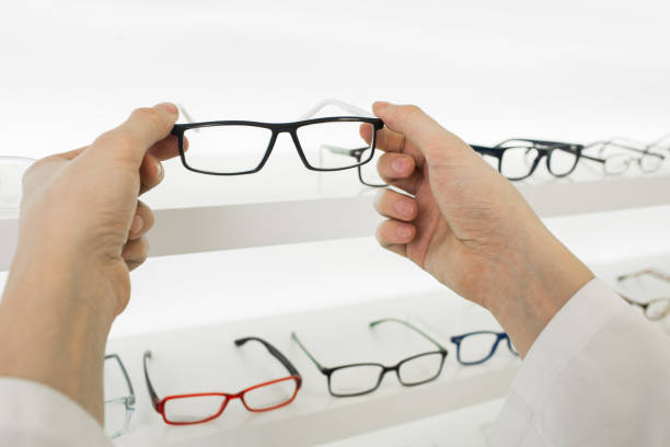istock doctor's hands and glasses, close-up 909946258
