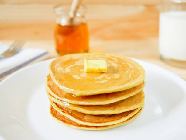 istock Stack of pancakes with butter and honey 909947452