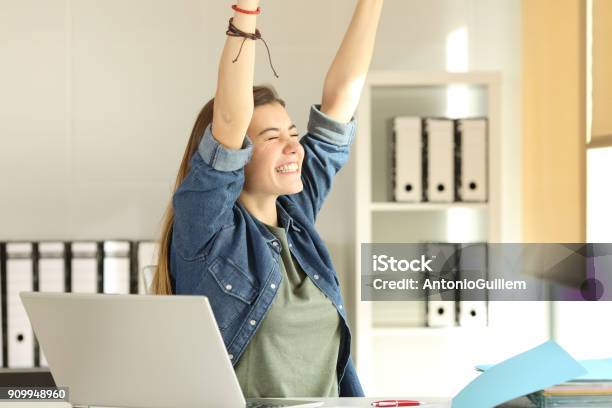 Satisfied Intern Raising Arms At Office Stock Photo - Download Image Now - Teenager, Trainee, Working