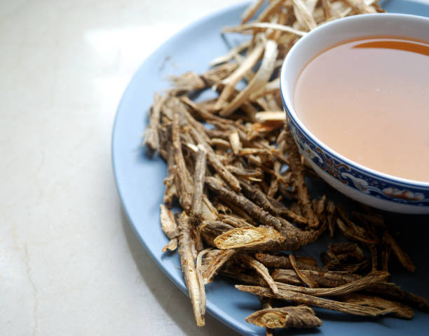 istock Bowl of chinese herb tea with dried assorted roots aside. 909949918