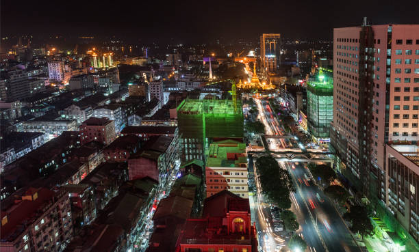 istock Lighted Sule Pagoda and its surrounding apartments at night, Yangon, Myanmar 909950270