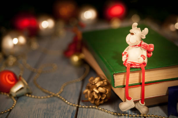 istock A Christmas deer toy sits on books 909955210