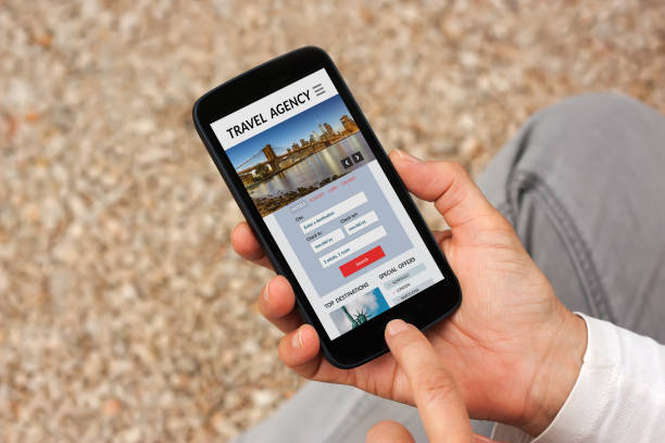 istock Hands holding smart phone with travel agency concept on screen 909955410