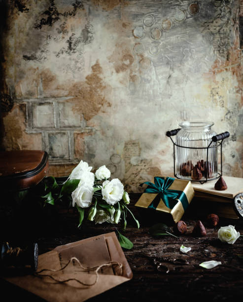 istock old envelope, eustoma flowers, gift box and glass jar with chocolate candies 909957446