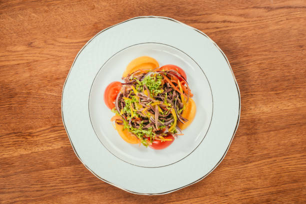 istock fresh vegetables sliced on white plate over wooden surface 909957480