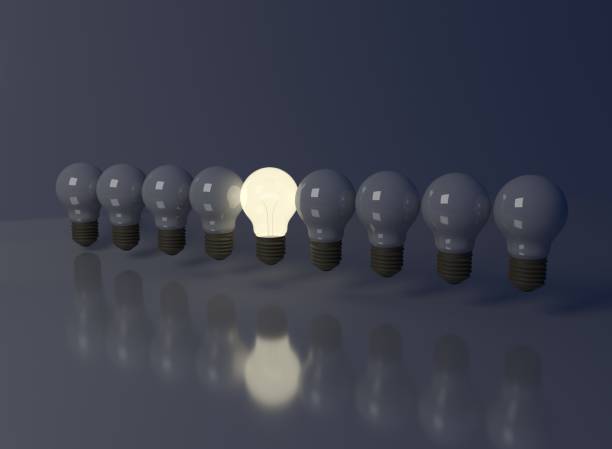 istock White lighting ball on the black background and other bulbs not lighted 909957660