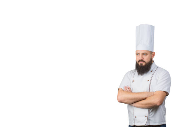 istock bearded Chef cook with crossed hands on white background, copy space on side. 909962826