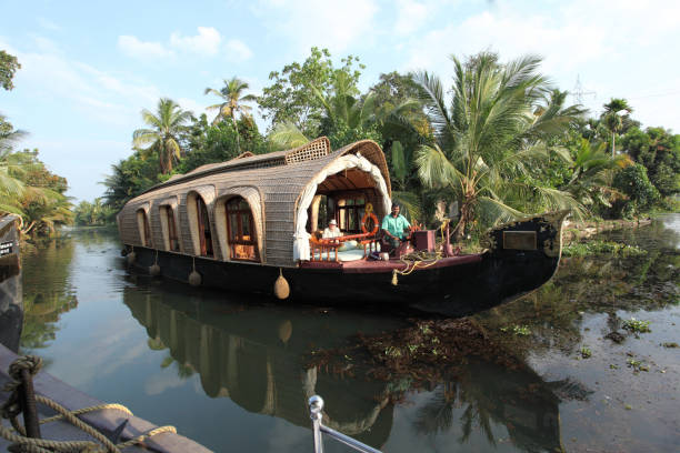 Alappuzha, Kerala, India - January 26, 2011: House boat operating in the backwaters of Kerala. House boat operating in the backwaters of Kerala. kerala south india stock pictures, royalty-free photos & images