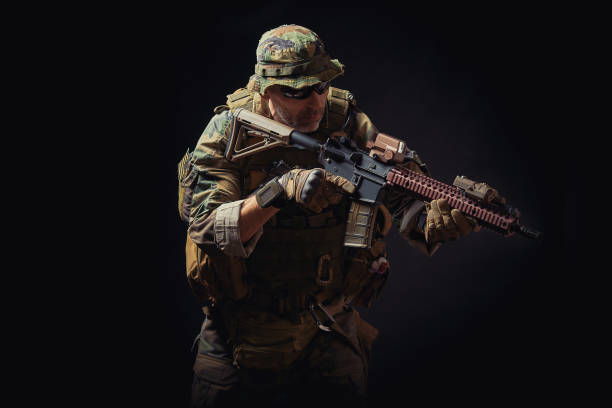 istock special forces soldier with a rifle is aiming at the target 909982492
