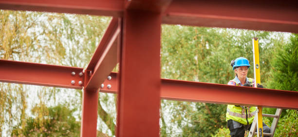 istock female steel erector checking levels 909986108